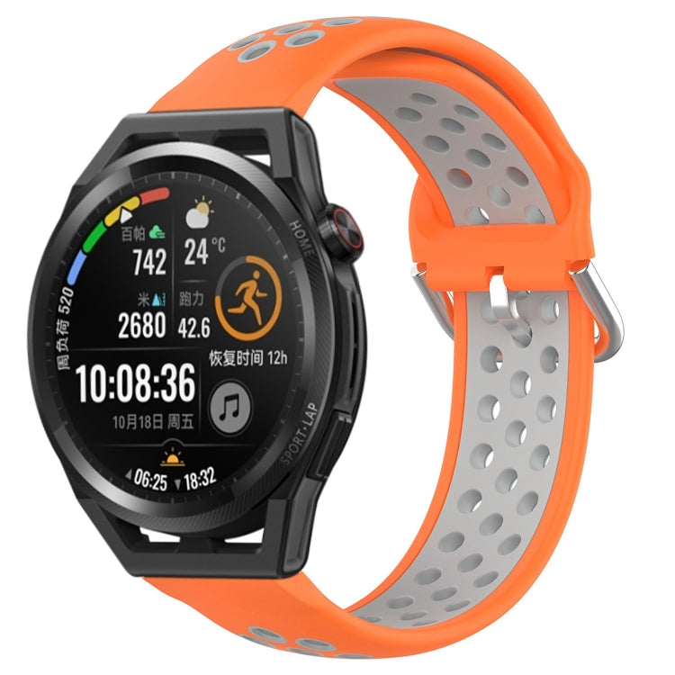 Orange perforated silicone sports watch band with black watch buckle and sporty vent holes