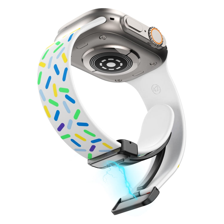 White silicone watch band with rainbow dots and black magnetic buckle, underside view
