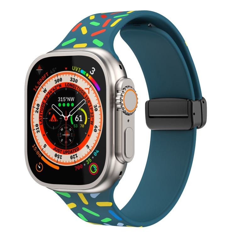 Silicone Apple Watch band with rainbow dots, teal-blue strap, black magnetic buckle clasp
