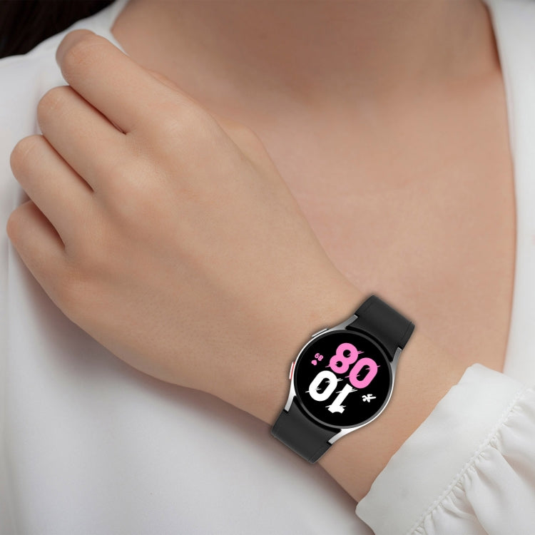 Black silicone leather watch band on wrist with buckle and perforated strap