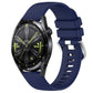 Glossy navy blue silicone watch band with silver buckle, punched holes, curved ends.