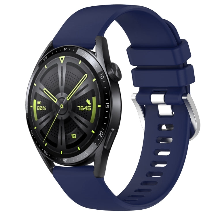 Glossy navy blue silicone watch band with silver buckle, punched holes, curved ends.