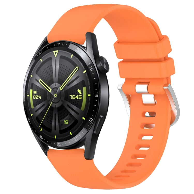 Glossy orange silicone watch band with silver buckle, punched holes, curved ends.