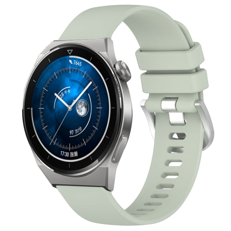 Light green silicone watch band with silver-tone buckle and link holes, glossy finish.