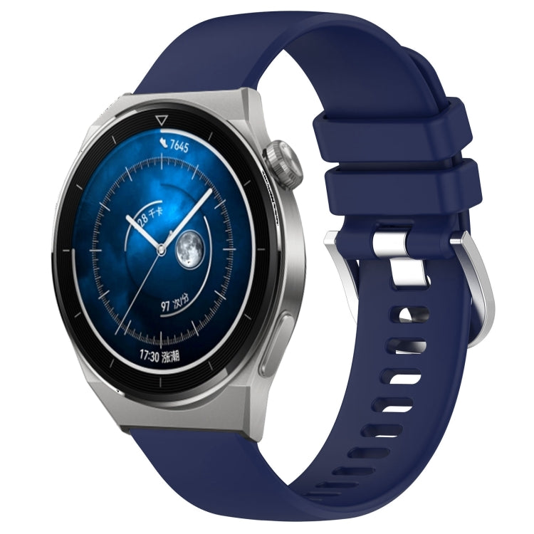 Blue silicone watch band with silver-tone buckle, glossy finish, and adjustment holes.