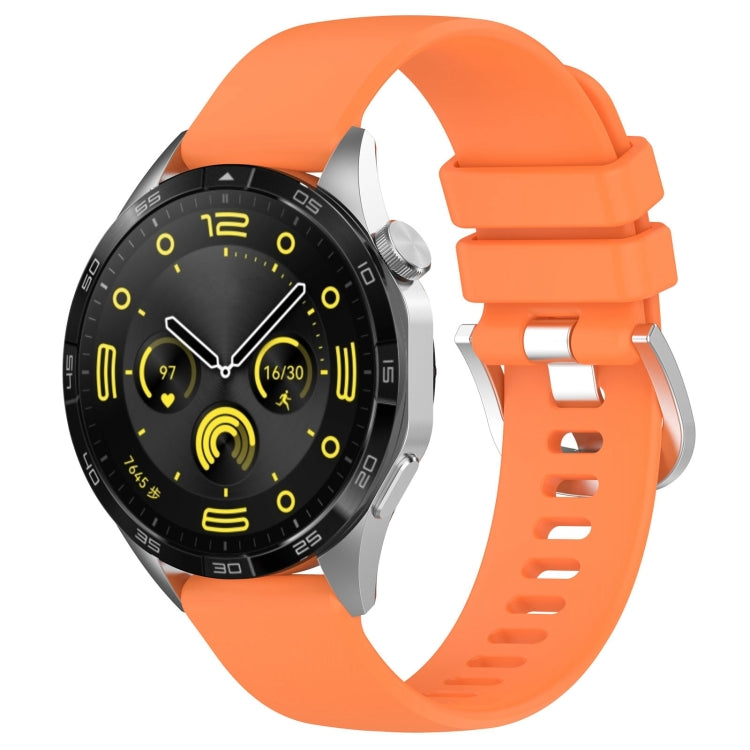Silicone watch band with silver buckle, orange glossy finish, vented strap holes.