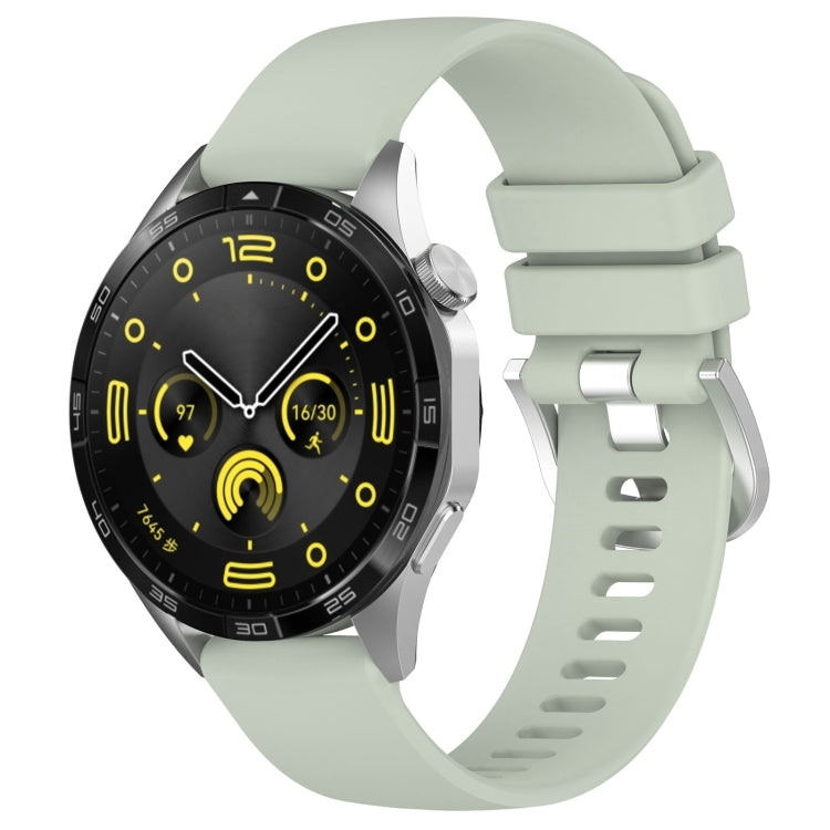 Silicone watch band with silver buckle, sage green glossy finish, vented strap holes.