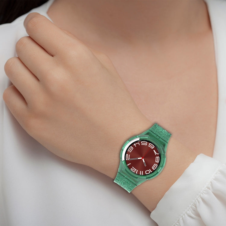Green TPU integrated watch band on wrist with red dial analog watch face