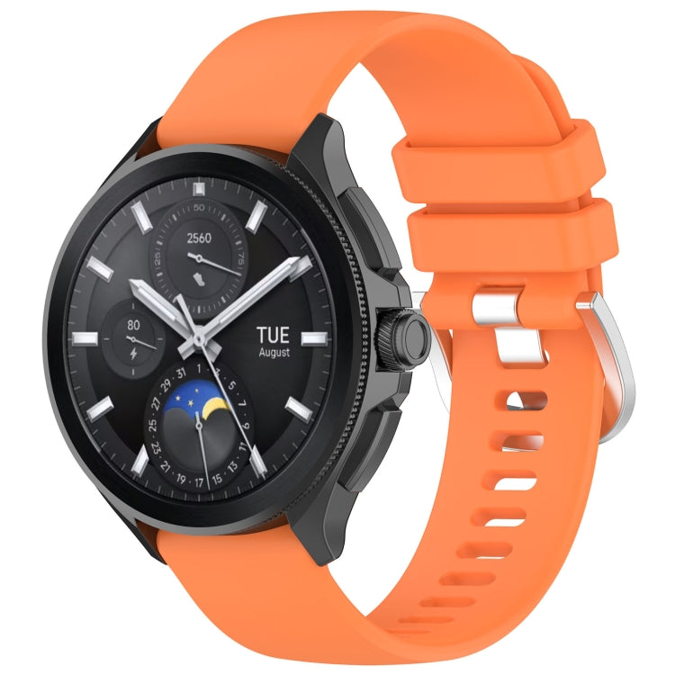 Orange glossy silicone watch band with sport buckle and perforated strap holes.