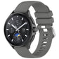 Dark gray glossy silicone watch band with sport buckle and perforated strap holes.