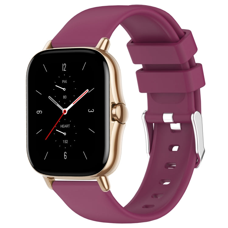Burgundy purple silicone watch band with adjustable holes and metal clasp.