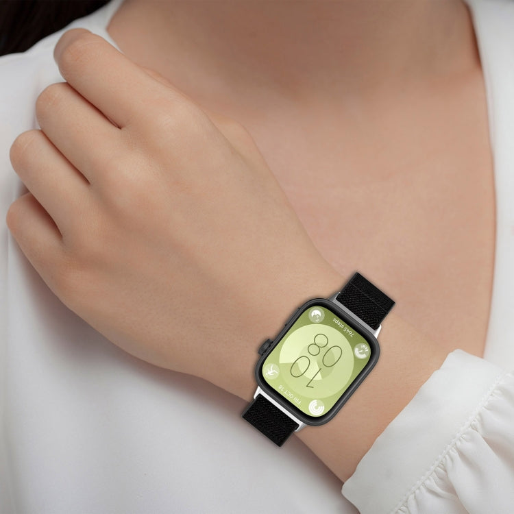Huawei Watch Fit 3 with a black elastic nylon band worn on a wrist