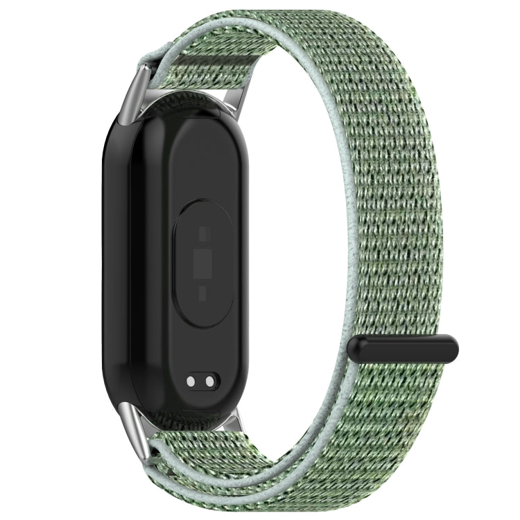 Back view of a pale green nylon watch band fitted to a fitness tracker