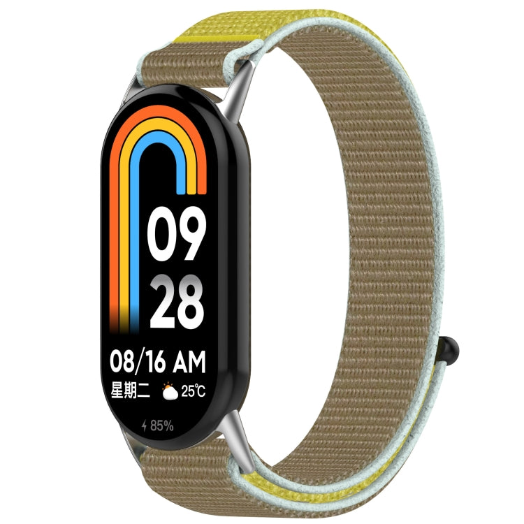 Khaki nylon hook-and-loop watch band with yellow accents, shown on a fitness tracker.