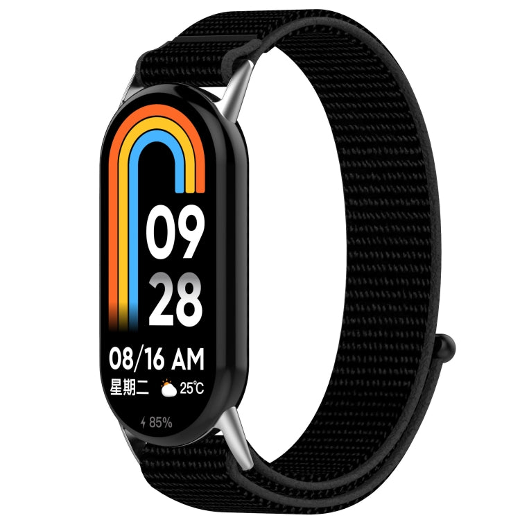 Black nylon hook-and-loop watch band shown on a fitness tracker.