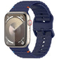 Navy blue silicone watch band with wavy ridges, shown attached to a smartwatch