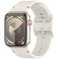 Off-white silicone Apple Watch band with wavy ridges and adjustable holes