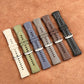 Six hybrid watch bands in white, olive, blue, gray, brown, and black, with metal buckles