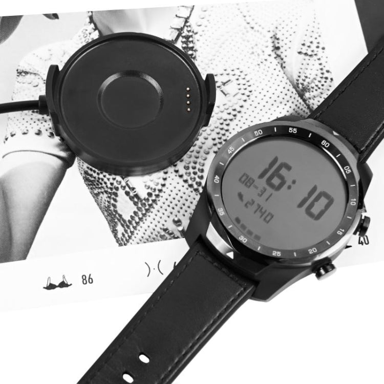 Magnetic charging puck and round smartwatch display with black leather-style strap