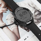 Smartwatch on black strap with magnetic charging cable and puck