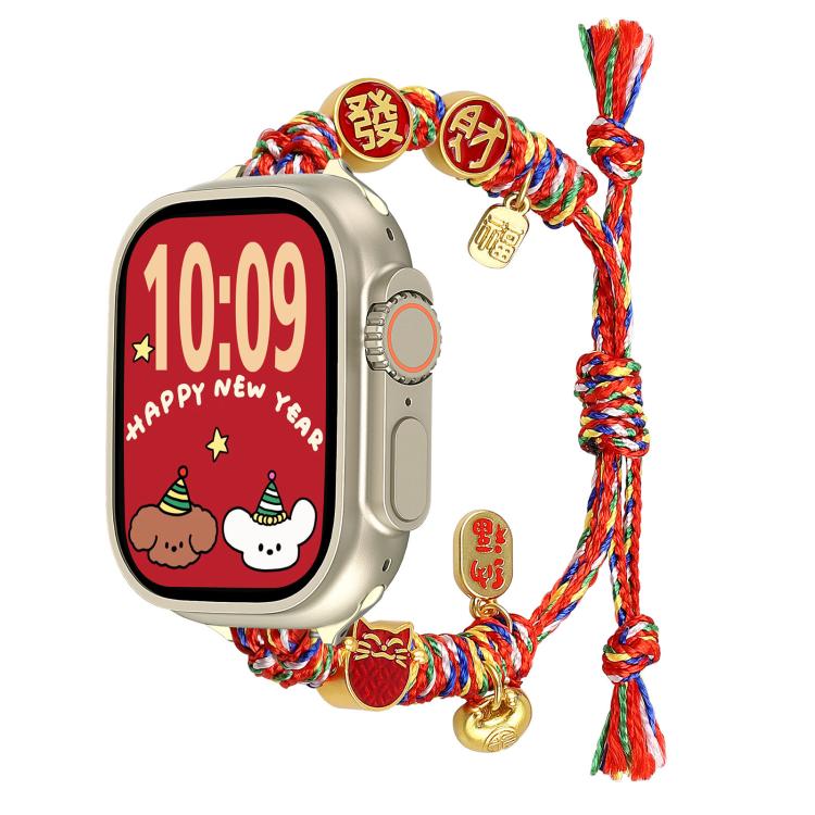 Multicolor braided Apple Watch band with red-and-gold fortune charms, shown on a watch