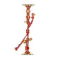 Multicolor braided Apple Watch band with red-and-gold charms and adjustable tie cords