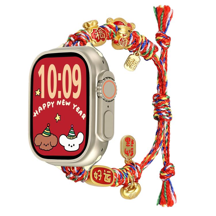 Multicolor braided Apple Watch band with gold fortune and cat charms, shown on a watch