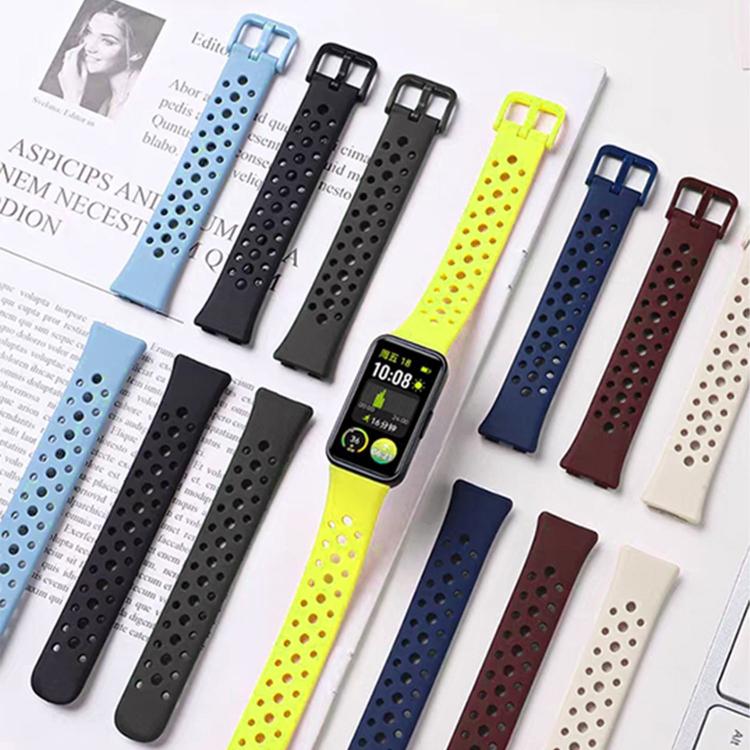 Assorted perforated silicone watch bands in multiple colors, laid out with buckles