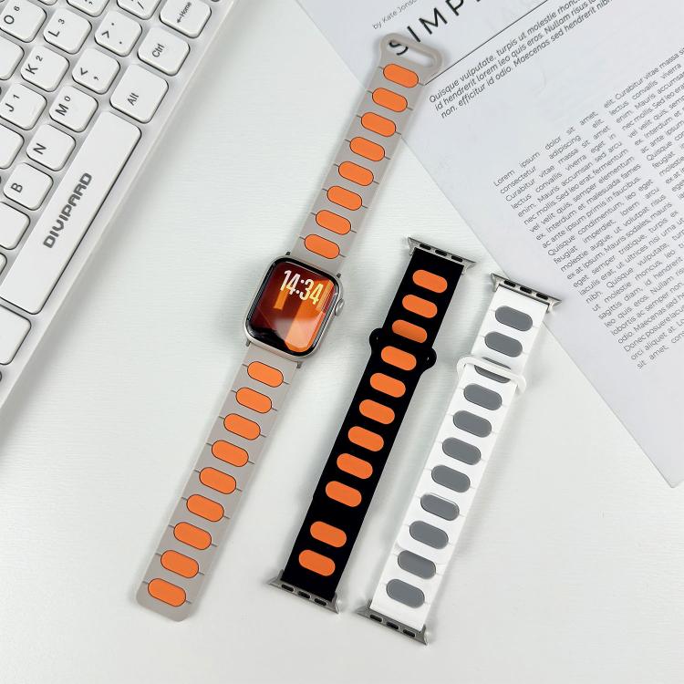 Light gray and black silicone watch bands with orange and gray oval insets.