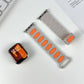 Separate light gray silicone band halves with orange or matching oval insets.