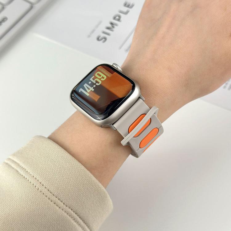 Light gray silicone magnetic watch band with orange insets, worn on a wrist.