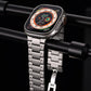 Silver metal watch band with broad links and butterfly clasp, attached to an Apple Watch