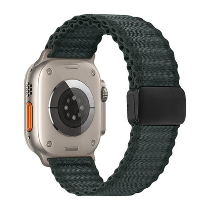 Dark gray braided nylon Apple Watch band with black magnetic buckle, shown on a watch