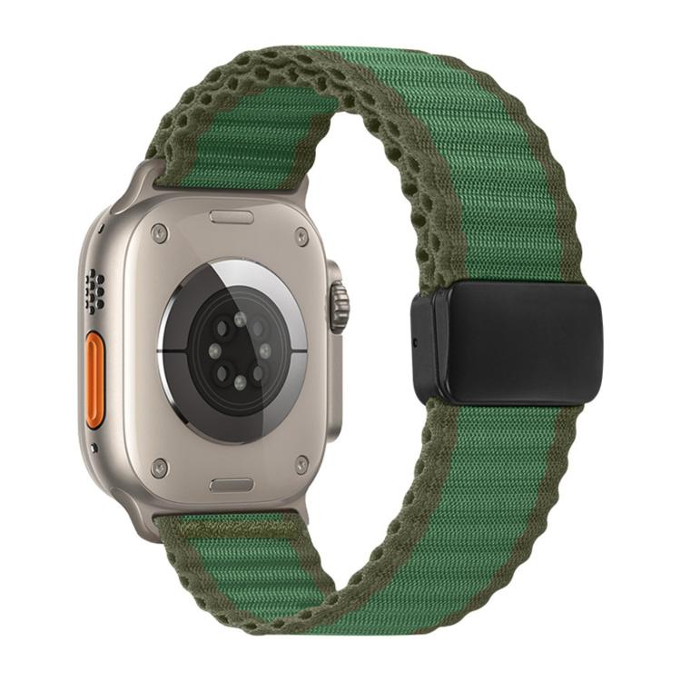 Green braided nylon Apple Watch band with black magnetic buckle, shown on a watch