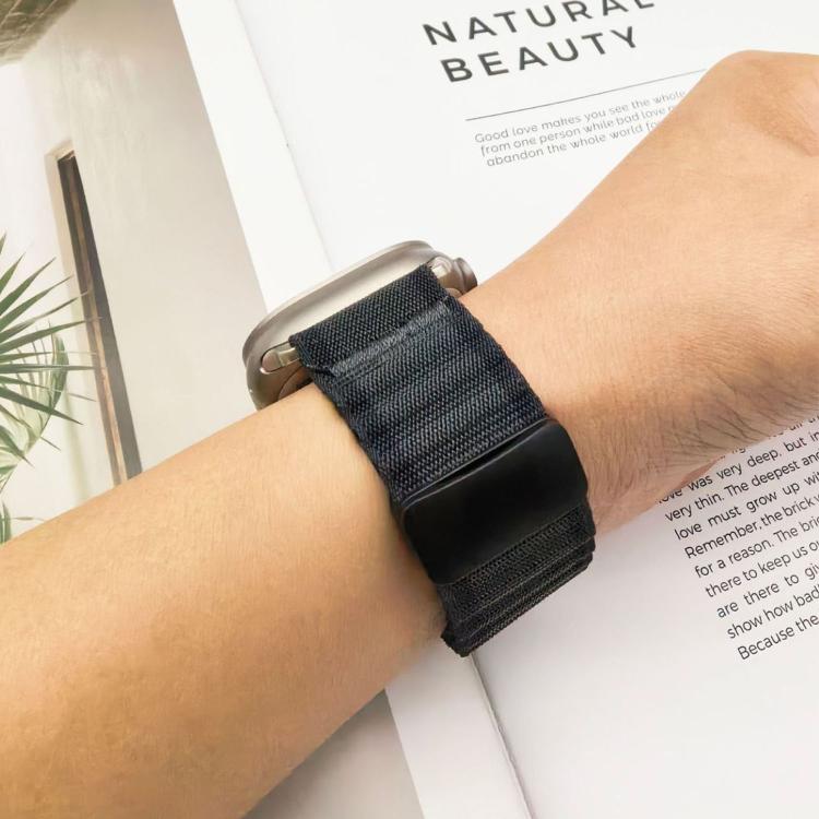 Dark braided nylon Apple Watch band with magnetic buckle, worn on a wrist