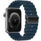Dark blue silicone watch band with perforated links and magnetic metal buckle