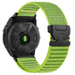 Lime green woven nylon watch band with black parachute buckle on a black watch