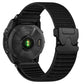Black woven nylon watch band with black parachute buckle on a black watch