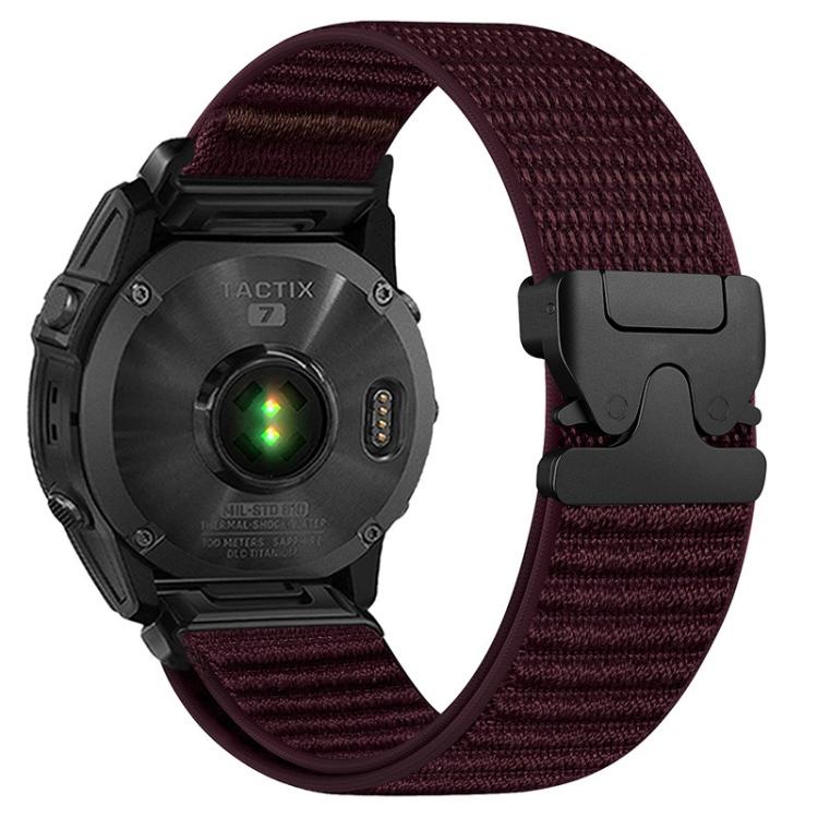Burgundy woven nylon watch band with black parachute buckle on a black watch