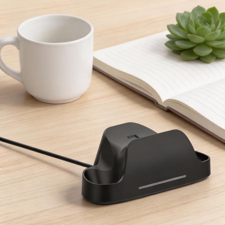 Black charging dock base with cable on tabletop, designed for game controller