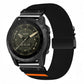 Black stretch nylon watch band with diagonal weave, black buckle, and orange accent