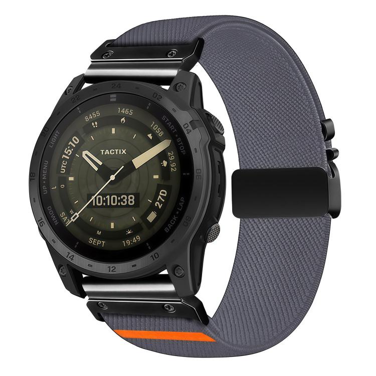 Gray diagonal-weave stretch nylon watch band with black buckle and orange accent, shown on a watch