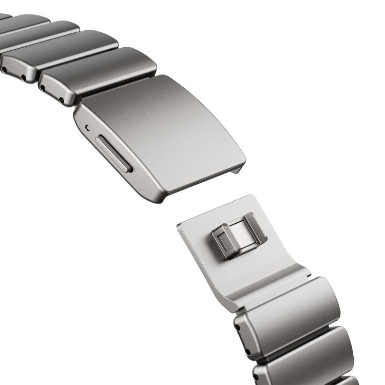 Close-up of a silver watch band magnetic clasp and interlocking metal links