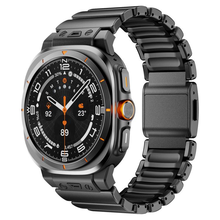 Watch band with black silicone links and a dark magnetic clasp on a black watch
