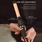 Automatic hair curler held in hand with black control area and gold barrel