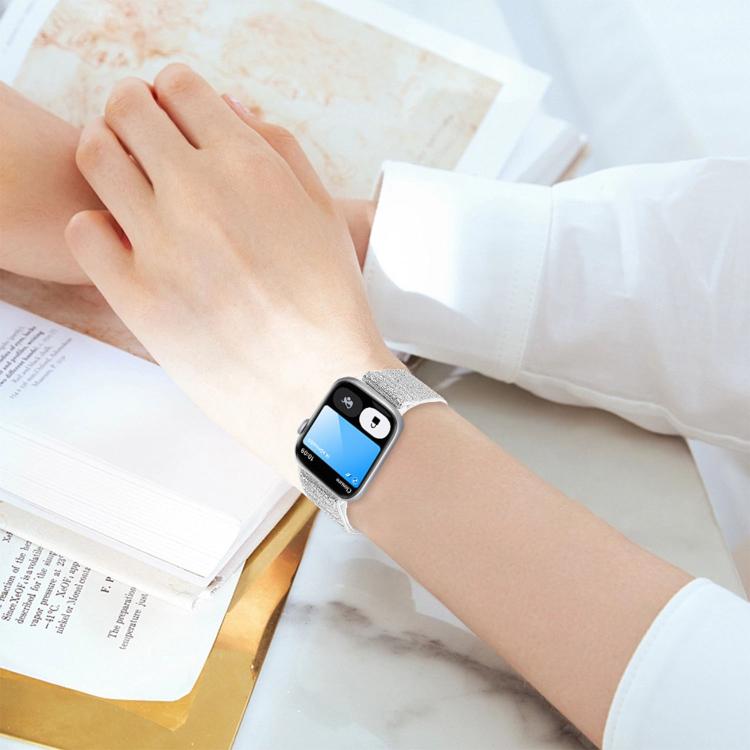 Silver glitter elastic nylon Apple Watch band worn on a wrist.