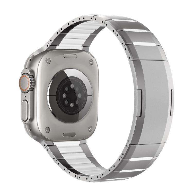 Two-tone stainless steel watch band with silver links and dark accents, shown attached to a watch