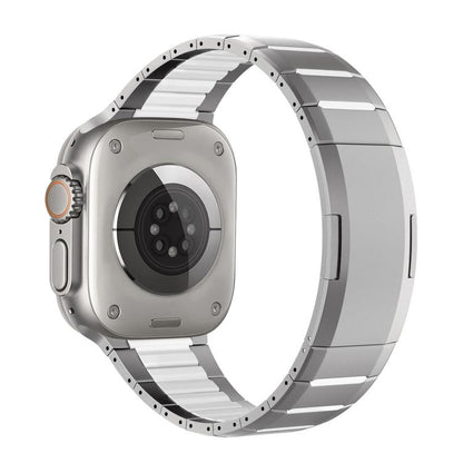 Two-tone stainless steel watch band with silver links and dark accents, shown attached to a watch