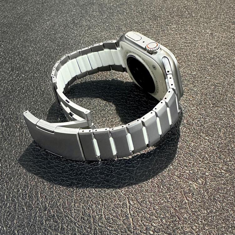 Silver stainless steel watch band with curved links and open side-release clasp