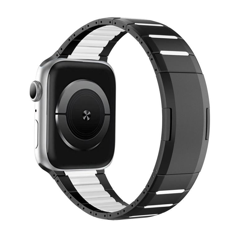 Stainless steel watch band with black and silver links, shown attached to a watch